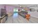 Spacious living room with grey couch and light flooring at 218 Glenellen Pl, Sun City Center, FL 33573