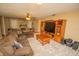 Spacious living room featuring a stone fireplace and large TV at 4805 Bugg Rd, Plant City, FL 33567