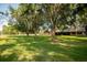 House with a spacious green lawn and large oak trees at 4805 Bugg Rd, Plant City, FL 33567