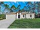 One-story home with attached garage and lawn at 11081 Horned Owl Rd, Weeki Wachee, FL 34614