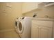 Laundry room with washer, dryer and cabinets at 4922 Sandy Brook Cir, Wimauma, FL 33598