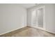 Empty bedroom with mirrored French doors and tile floors at 809 Snail Kite Pl, Sun City Center, FL 33573