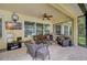 Relaxing screened patio with seating area and TV at 6619 Current Dr, Apollo Beach, FL 33572