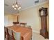 Bright dining room featuring a wood table and grandfather clock at 6619 Current Dr, Apollo Beach, FL 33572
