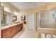 Elegant bathroom with double vanity, granite countertops, and a large shower at 6619 Current Dr, Apollo Beach, FL 33572