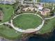 Community park featuring a large open lawn, walking paths, and palm trees at 6619 Current Dr, Apollo Beach, FL 33572