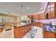 Open kitchen with a large island, stainless steel appliances, and wood cabinets at 6619 Current Dr, Apollo Beach, FL 33572