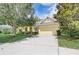 House exterior, yellow siding, landscaping, driveway at 6619 Current Dr, Apollo Beach, FL 33572