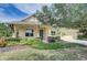 Beautiful yellow house with a landscaped yard and inviting front porch at 6619 Current Dr, Apollo Beach, FL 33572