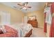 Well-lit bedroom with queen bed, dresser and ceiling fan at 6619 Current Dr, Apollo Beach, FL 33572