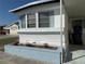 Charming exterior of the home with a large window, car port, and a cute flower box at 116 W Saint Johns Way, Apollo Beach, FL 33572