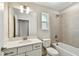 Bathroom with vanity, sink, toilet and tiled shower-bath combo at 7201 S De Soto St, Tampa, FL 33616
