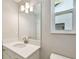 Bathroom featuring modern vanity, stylish lighting, sink and toilet at 7201 S De Soto St, Tampa, FL 33616