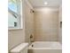 Bathroom with tiled shower and bath and toilet at 7201 S De Soto St, Tampa, FL 33616
