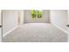 Neutral bedroom with a window view of lush greenery and neutral carpet and walls at 7201 S De Soto St, Tampa, FL 33616