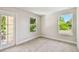 Inviting bedroom features neutral carpeting, a balcony access door, and large windows offering a bright, airy atmosphere at 7201 S De Soto St, Tampa, FL 33616