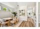 Bright dining room features an oval table, stylish chairs, and modern decor, filled with natural light from nearby windows at 7201 S De Soto St, Tampa, FL 33616