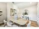 Well-lit dining room includes a rustic wood table, soft neutral chairs, and refined decor, offering an inviting space at 7201 S De Soto St, Tampa, FL 33616