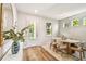 Entryway featuring a white door, light wood floors, and contemporary decor creates a welcoming and bright arrival at 7201 S De Soto St, Tampa, FL 33616