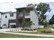 Striking two-story home with a modern design and beautifully landscaped front yard at 7201 S De Soto St, Tampa, FL 33616