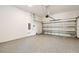 Spacious garage showcasing a clean epoxy floor and an insulated garage door, ready for your vehicles or projects at 7201 S De Soto St, Tampa, FL 33616