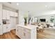 Bright kitchen with a center island and white cabinets, seamlessly flowing into the adjacent living space at 7201 S De Soto St, Tampa, FL 33616