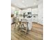 Bright kitchen with white cabinetry, stainless steel appliances, and a central island with bar stool seating at 7201 S De Soto St, Tampa, FL 33616