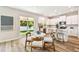 Eat-in kitchen featuring white cabinets, stainless steel appliances, a center island, and backyard access at 7201 S De Soto St, Tampa, FL 33616