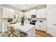 Well-equipped kitchen featuring white cabinets, quartz countertops, stainless steel appliances, and an island at 7201 S De Soto St, Tampa, FL 33616
