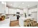 Bright kitchen with white cabinets, stainless steel appliances, quartz countertops, and a kitchen island at 7201 S De Soto St, Tampa, FL 33616
