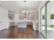 Open kitchen featuring gray cabinets, an island, and a view to the backyard at 7201 S De Soto St, Tampa, FL 33616