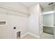 Efficient laundry room showcases tile floors, wire shelving, and easy access to hookups for laundry appliances at 7201 S De Soto St, Tampa, FL 33616