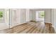 Bright living room showcasing beautiful wood floors and multiple entryways, creating an open and inviting space at 7201 S De Soto St, Tampa, FL 33616
