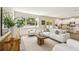 Bright living room featuring a sofa, a wooden table, and access to the kitchen, ideal for modern living and entertaining at 7201 S De Soto St, Tampa, FL 33616