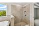 Elegant bathroom with a tiled shower, and a soaking tub with quartz surround, offering a spa-like experience at 7201 S De Soto St, Tampa, FL 33616
