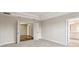 Spacious carpeted main bedroom with double doors, leading to an ensuite bathroom and walk-in closet at 7201 S De Soto St, Tampa, FL 33616