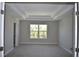 Spacious bedroom featuring a tray ceiling, large window and plush carpeting for a luxurious and inviting feel at 7205 S De Soto St, Tampa, FL 33616