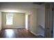 Upstairs bedroom with wood-look flooring and fresh paint at 7205 S De Soto St, Tampa, FL 33616