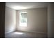Bright bedroom with a window, plush carpeting, and neutral paint create a cozy, inviting atmosphere at 7205 S De Soto St, Tampa, FL 33616