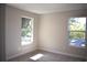 Cozy bedroom with two windows providing ample natural light and a comfortable carpeted floor at 7205 S De Soto St, Tampa, FL 33616