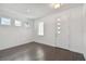 Open entryway with modern white door, wood floors, and ample natural light at 7205 S De Soto St, Tampa, FL 33616