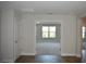 Entryway featuring an open view to the living space with hardwood floors and fresh, neutral paint at 7205 S De Soto St, Tampa, FL 33616