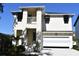 Charming two-story home featuring a clean white exterior and an attached two-car garage at 7205 S De Soto St, Tampa, FL 33616