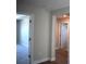 Hallway with hardwood and carpet flooring showcases the transition between rooms, highlighting the home's design at 7205 S De Soto St, Tampa, FL 33616