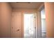 Hallway with two white doors showcases the home's interior layout and accessibility between rooms at 7205 S De Soto St, Tampa, FL 33616