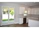 Modern kitchen features white cabinetry, an island, stainless steel appliances, and neutral countertops at 7205 S De Soto St, Tampa, FL 33616