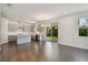 Modern kitchen with gray cabinets, island, stainless steel appliances, and sliding glass doors at 7205 S De Soto St, Tampa, FL 33616