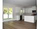 Spacious kitchen with modern white cabinets, stainless steel appliances, and a center island at 7205 S De Soto St, Tampa, FL 33616