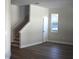 Bright living room with wood floors, a window, and a staircase leading to the second floor at 7205 S De Soto St, Tampa, FL 33616