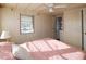 Bright bedroom with a pink comforter, ceiling fan and a view of a window at 116 W Saint Johns Way, Apollo Beach, FL 33572